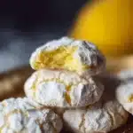 Freshly baked Lemon Crinkle Cookies dusted with powdered sugar.