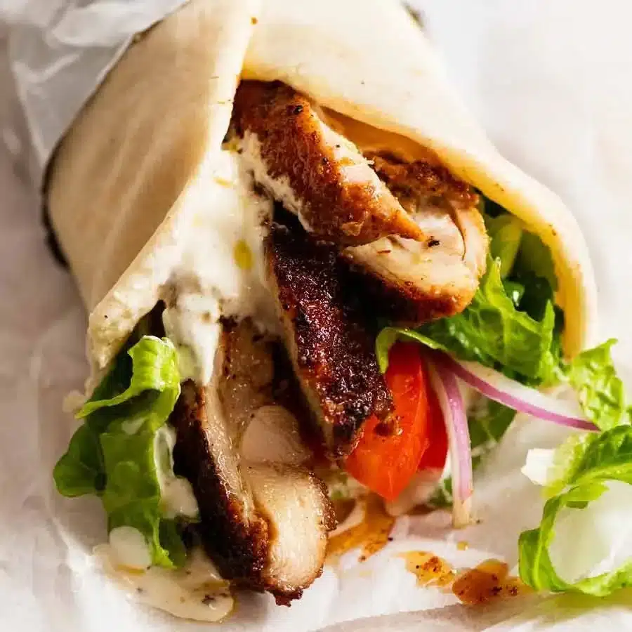 Delicious Chicken Shawarma served with fresh vegetables and pita bread.
