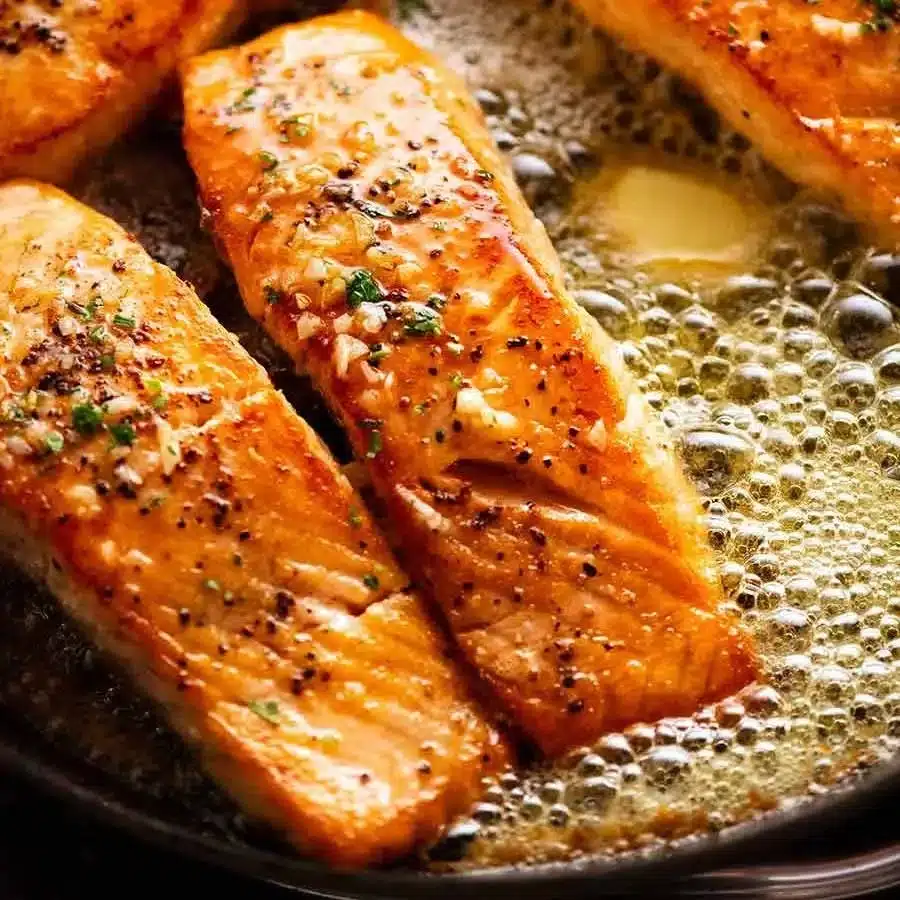 Garlic butter salmon fillet cooked to perfection with herbs and spices.