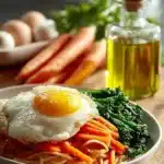 Plate of crispy Korean fried noodles stir-fried with vegetables and toppings
