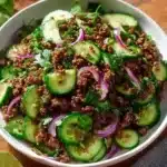 Plate of Spicy Korean Ground Beef served with a fresh Cucumber Salad.