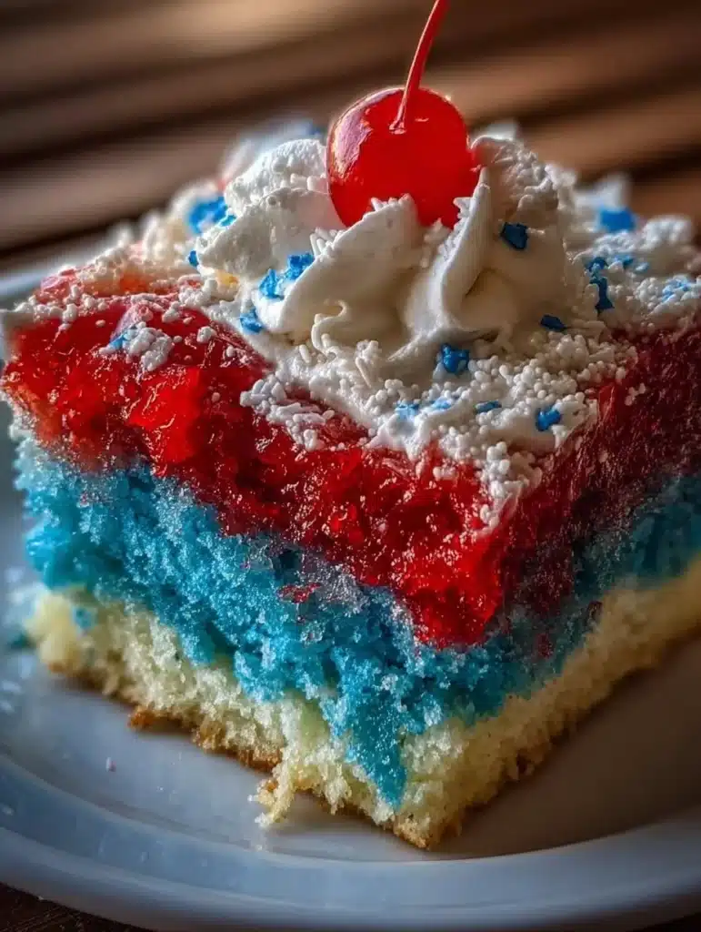 Patriotic Red, White, and Blue Poke Cake topped with whipped cream and berries.