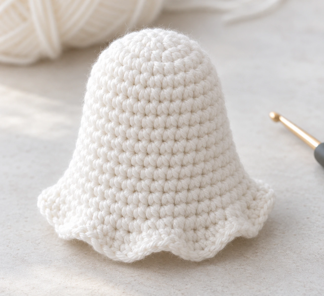 Crocheted white ghost body with a rounded top and flared hem made in the round
